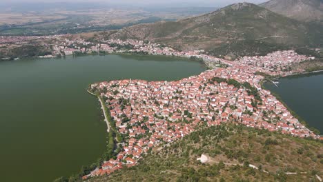 Aerial-clip-over-a-mouintain-and-the-city-and-lake-of-Kastoria,-in-northern-Greece