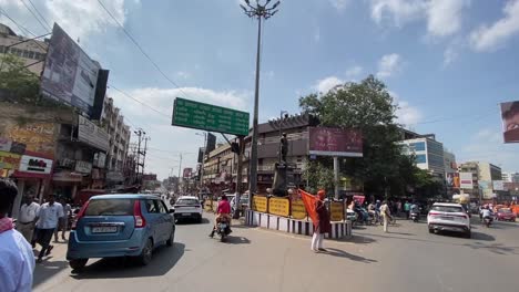 POV-shot-of-two-way-road-with-heavy-traffic-movement-in-Dhanbad,-India-on-a-bright-sunny-day