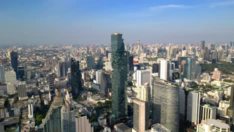 Drone-Shot-of-Mahanakhon-Tower-skywalk,-rooftop,-in-Bangkok,-Silom-area,-business-district,-downtown