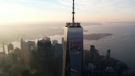 Aerial-view-around-the-Freedom-tower,-sunrise-in-Lower-Manhattan,-NY---orbit,-drone-shot