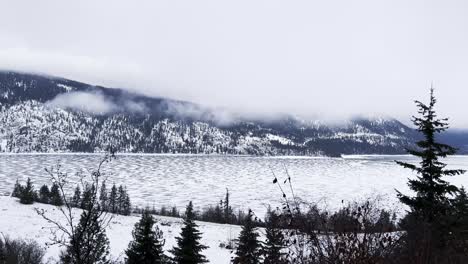 Slow-pan-of-Shuswap-Lake-covered-in-snow-and-ice-British-Columbia-Canada