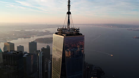 Aerial-view-circling-around-the-One-World-Trade-Center,-fall-golden-hour-in-NY