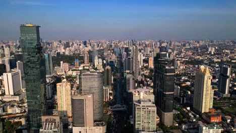 Drone-Shot-Skyline-of-Bangkok-city,-skyscrapers,-Mahanakhon-Tower,-Business-district,-traffic-busy-streets