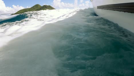 Seychelles,-St-Anne-marine-park,-Boat-breaking-waves-heading-forward