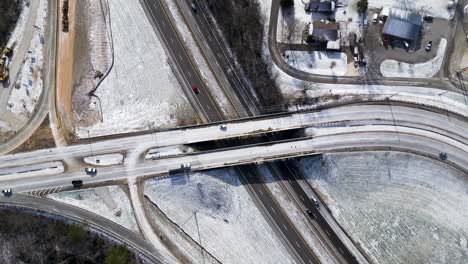 highway-exist-in-winter-with-snow,-Ariel-drone-shot,-freeway-exit-covered-with-with-snow