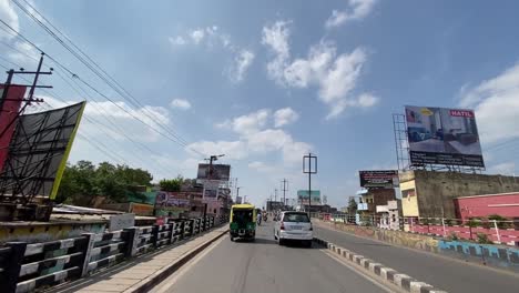 POV-shot-while-driving-over-an-over-bridge-in-Dhanbad,-India-on-a-sunny-day