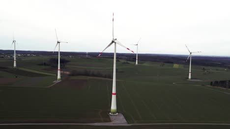 Aerial-Shot-of-Rotating-Windmills-on-a-Field-in-Sauerland,-Germany