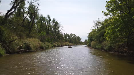 People-Kayaking-In-Peaceful-Quiet-River,-Exploring-Wild-Nature