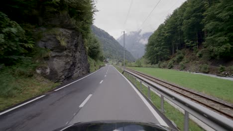 Driving-in-the-Lauterbrunnen-valley,-a-famous-travel-destination-in-Switzerland