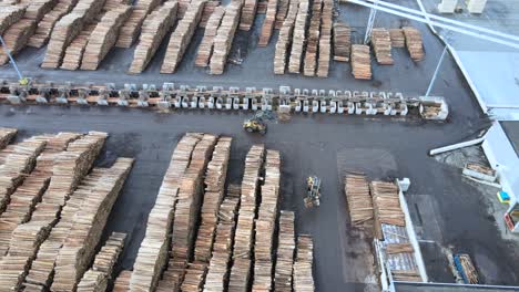 Overhead-Perspective-of-Wood-Manufacturing-Facility-in-Germany,-with-Stacks-of-Pine-Logs-and-Busy-Machinery-at-Work
