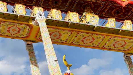 Flying-carpet-carousel-at-fairground-moving-with-one-child-on-board