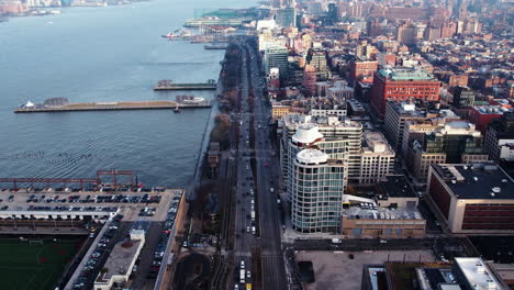 Aerial-view-of-traffic-on-the-West-Street,-sunny-fall-morning-in-NY---reverse,-drone-shot