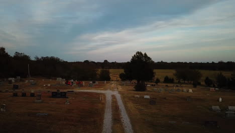 Backward-dolly-shot-of-a-person-walking-through-a-cemetery