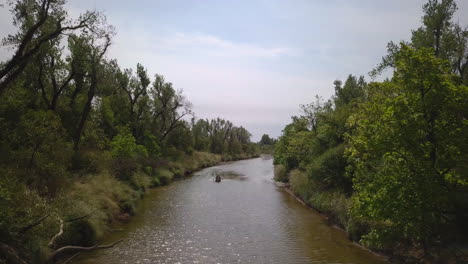 People-Kayaking-In-Peaceful-Calm-Water-River,-Exploring-Wild-Nature
