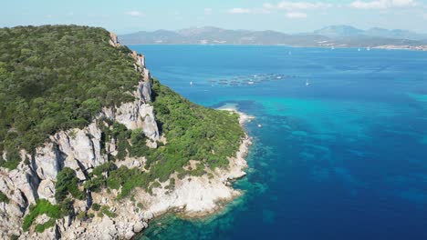 Figarolo-Island,-surrounded-by-turquoise-blue-mediterranean-sea-in-Sardinia,-Italy---4k-Aerial