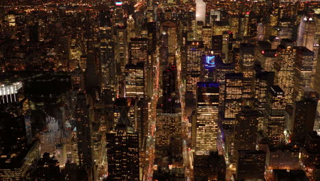 Flying-Around-New-York-City-Skyline-At-Night-With-New-World-Trade-Centre-Building-In-The-Urban-Business-District