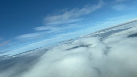 Stunning-view-from-a-jet-cockpit-on-a-right-turn-flying-over-the-clouds