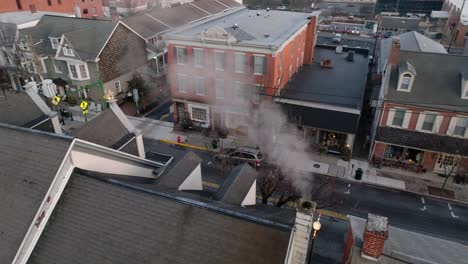 Rooftop-view-of-chimney-with-smoke-in-cold-winter-scene