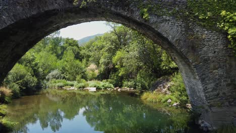 Flight-over-the-Sil-River-and-under-an-ancient-Roman-Bridge-in-rural-Spain