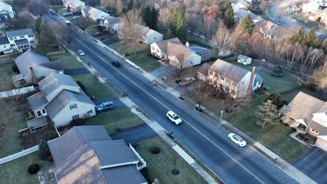 Traffic-on-street-through-residential-community-in-USA-during-winter-season