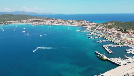 Golfo-Aranci-Port-and-coastal-town-in-Sardinia,-Italy---4k-Aerial-Backwards