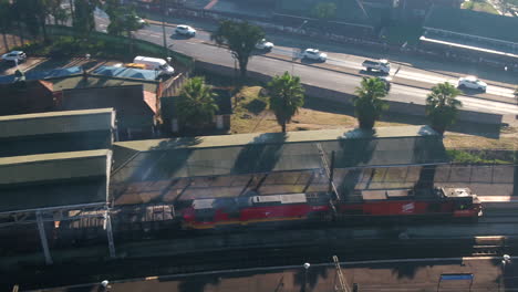 Drone-shot-of-Commercial-Spoornet-train-in-south-africa-leaving-a-train-station