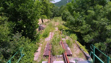 Train-point-of-view-over-an-old-bridge-and-unused-and-forgotten-railroad-track