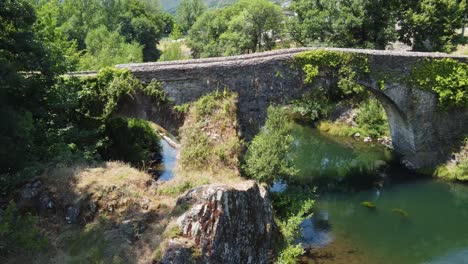 Flight-over-an-old-railroad-bridge-and-an-ancient-bridge-from-Roman-times-in-Spain
