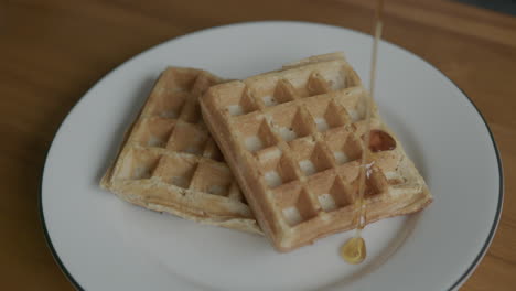 Close-Up-Slow-Motion-of-Syrup-Being-Poured-onto-Waffles