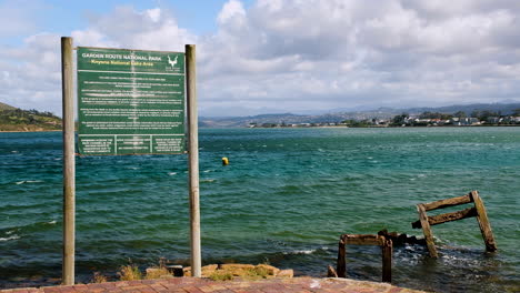 Garden-Route-National-Park-warning-and-indemnity-board-on-edge-of-Knysna-Lagoon