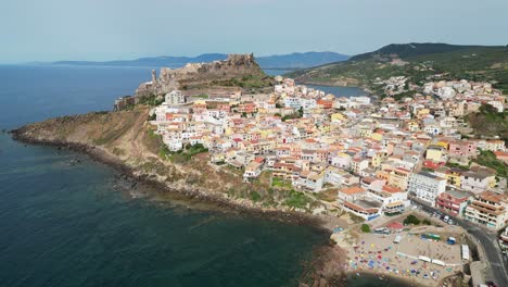 Castelsardo-beach-and-fortified-town-in-Sardinia,-Italy---4k-Drone-Aerial-Pedestal-Up