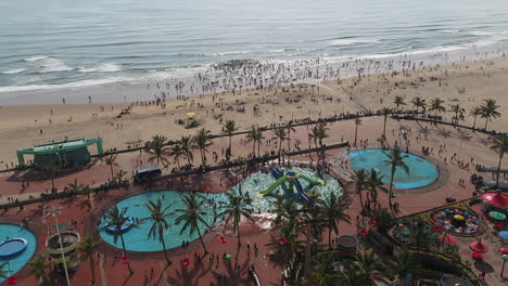 Drone-shot-ion-Large-crowds-on-Durban-beachfront-in-the-public-pools-and-ocean