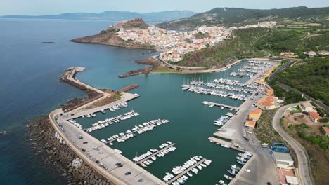 Castelsardo-harbor-and-fortified-town-in-Sardinia,-Italy---4k-Drone-Aerial-Forward