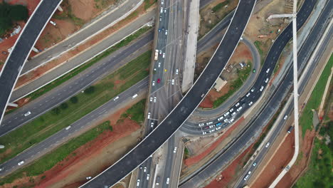 Birds-eye-drone-shot-over-busy-highway-interchange-with-cars-and-roads-still-being-built,-Durban-South-Africa