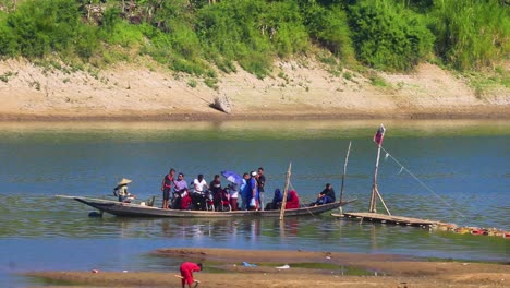Traditional-Ghat-boat-transporting-people-in-Bangladesh,-handheld-view