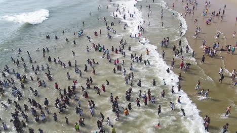 Drone-shot-of-Large-crowds-in-the-ocean-waves-in-Durban-South-Africa