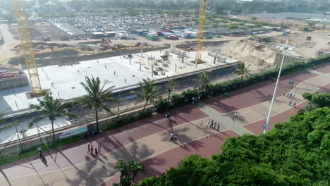 Drone-shot-along-Durban-promenade-with-construction-happening-at-Sun-coast-casino-Durban,-South-Africa