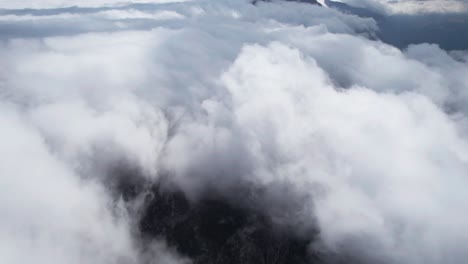 Cloudy-mountains,-aerial-drone-flies-above-clouds-in-Thermessos,-Antalya,-Turkey