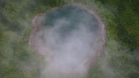 Drone-above-misty-clouds-over-crater-lake-Lagoa-Rasa,-São-Miguel-Island,-Azores