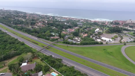 Drone-track-along-a-highway-in-South-Africa-with-the-Indian-Ocean-inn-the-background
