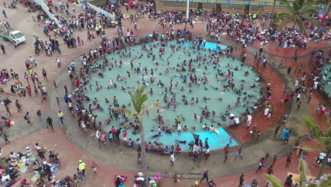 Drone-onto-large-crowds-on-Durban-South-Africa-Beachfront-and-public-pools