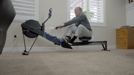 Senior-man-rowing-machine-exercise---sliding-low-angle