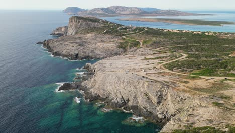 Rocky-Coastline-at-La-Pelosa-with-views-at-Asinara-National-Park,-Sardinia---Aerial-4k