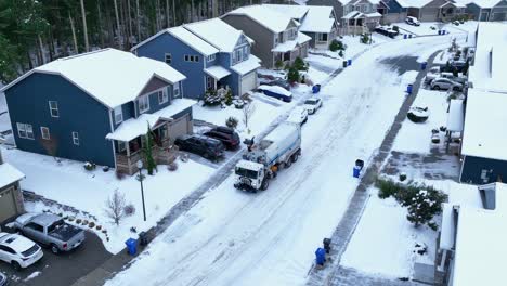 Aerial-shot-of-a-dump-truck-making-the-rounds-and-picking-up-trash