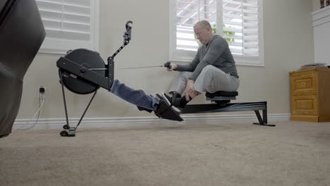 Senior-man-finishes-his-workout-on-a-rowing-machine