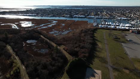 An-aerial-view-over-a-park-by-the-salt-marshes-in-Freeport,-NY-on-a-sunny-day-with-blue-skies