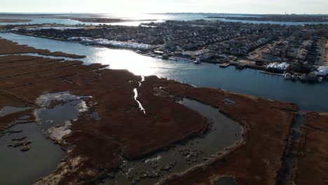 An-aerial-view-over-the-salt-marshes-in-Freeport,-NY-on-a-sunny-day