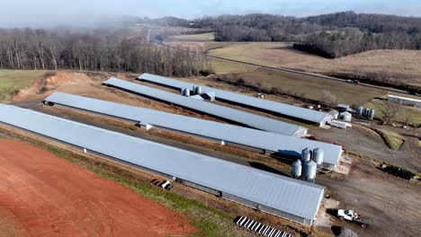 aerial-slow-push-over-chicken-farm-in-wilkes-county-nc,-north-carolina
