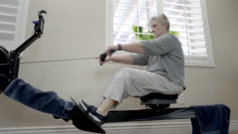 Senior-woman-exercising-on-a-rowing-machine-at-home