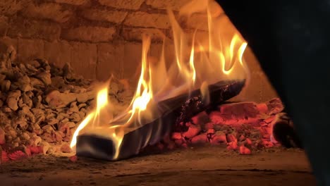 Close-up-of-log-of-wood-burning-in-slow-motion-in-the-typical-oven-for-pizza-in-Naples